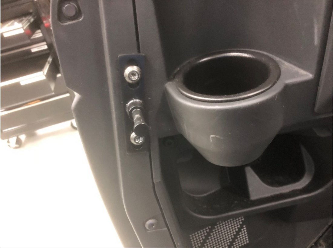 Spike door striker mounted where the net buckle bracket was