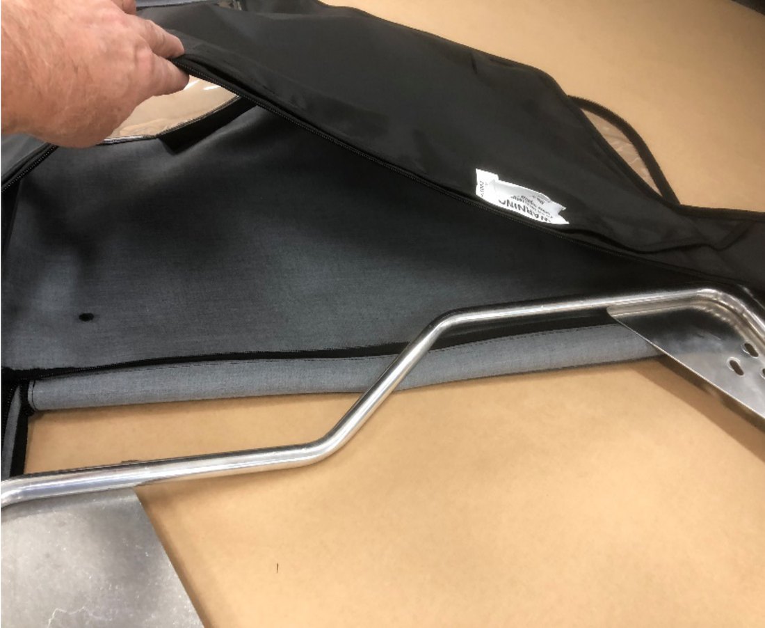Fabric door covering being pulled onto the lower portion of the door frame