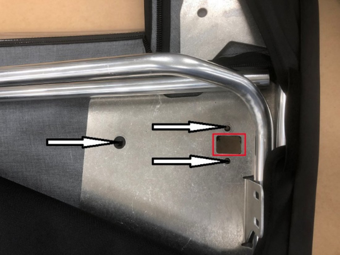 Locations for the three handle bolt holes and rectangular cutout marked on the door handle plate